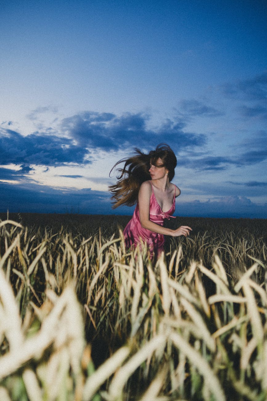 evening photo of a teenage girl running and looking back