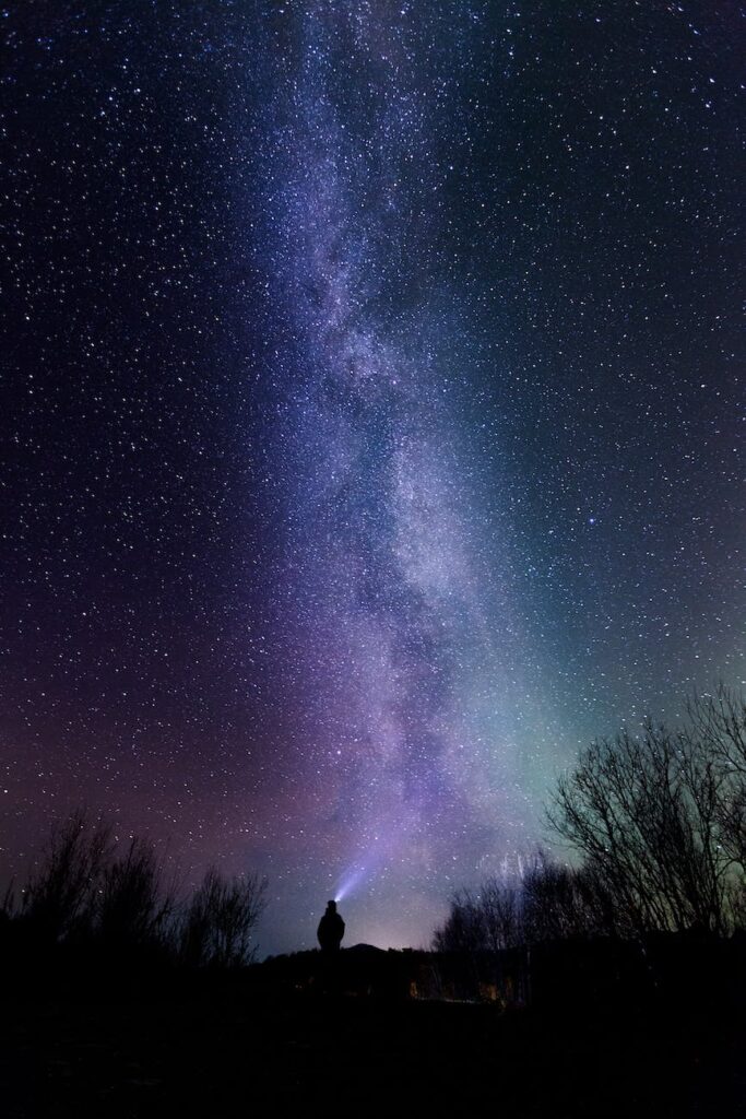 silhouette photography of person under starry sky