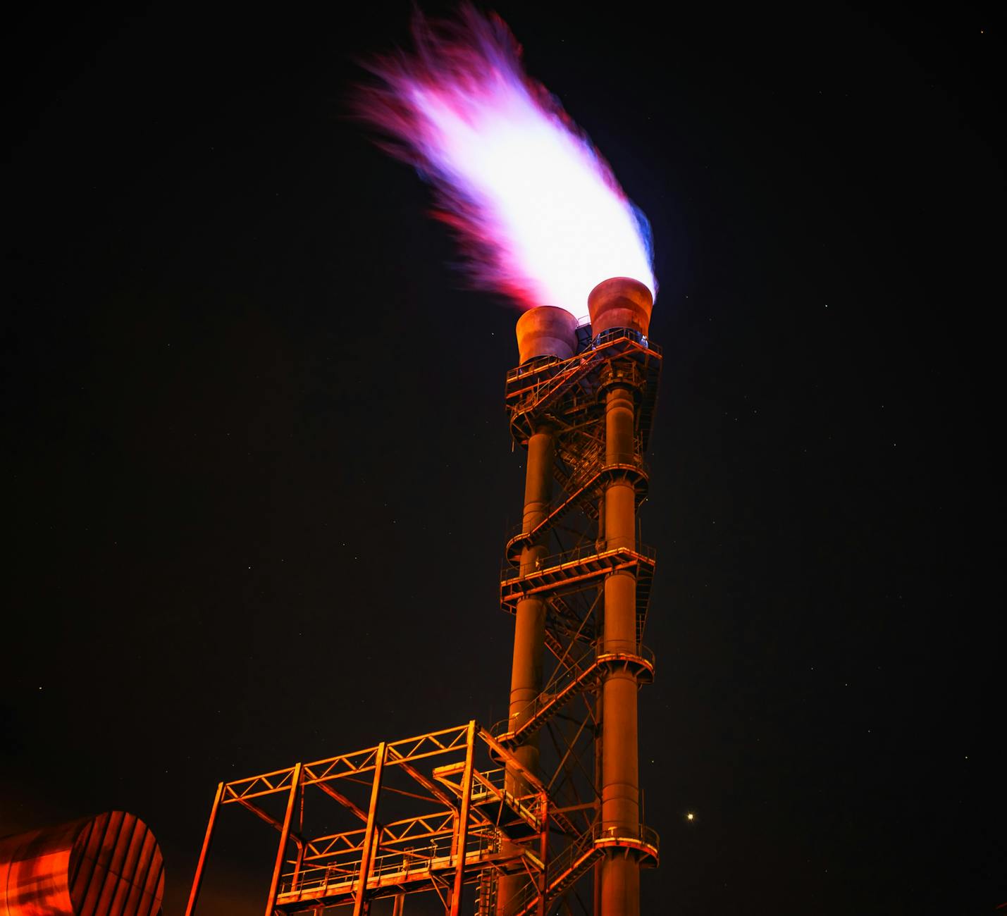 low angle view of illuminated tower against sky at night