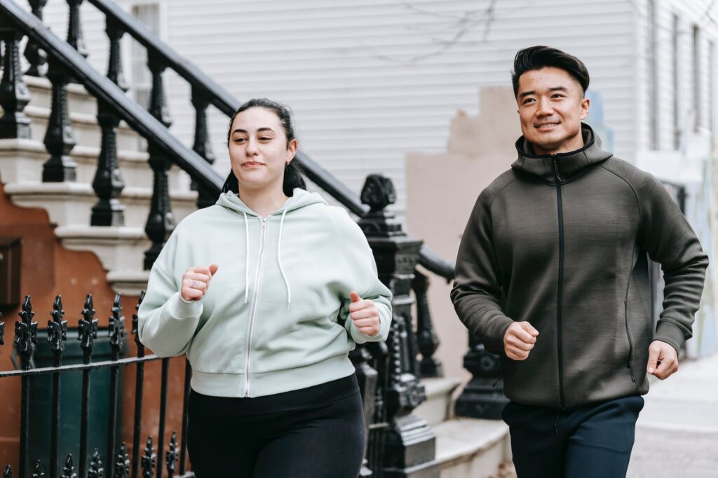 plus sized female running with asian man on street in daytime